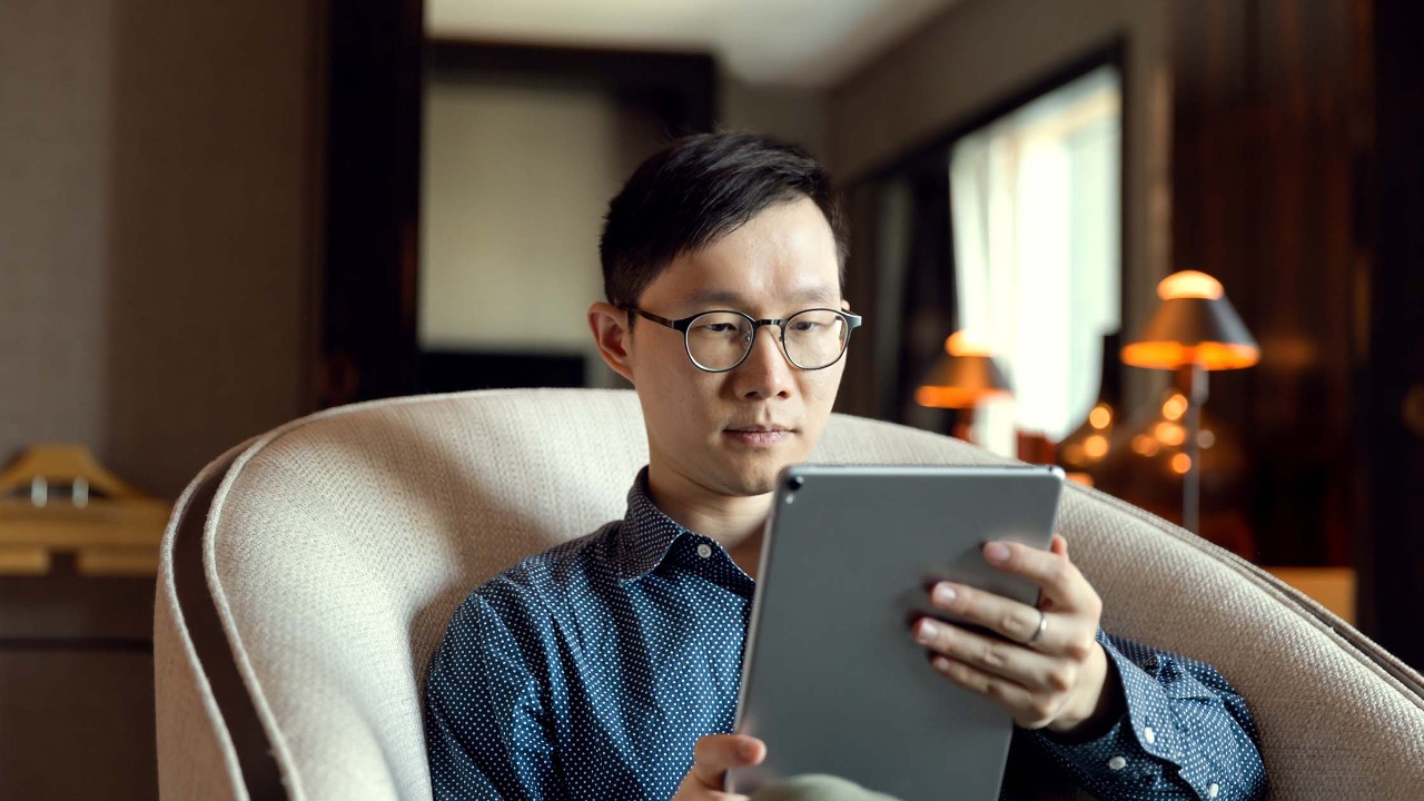 Man uses touchpad in hotel