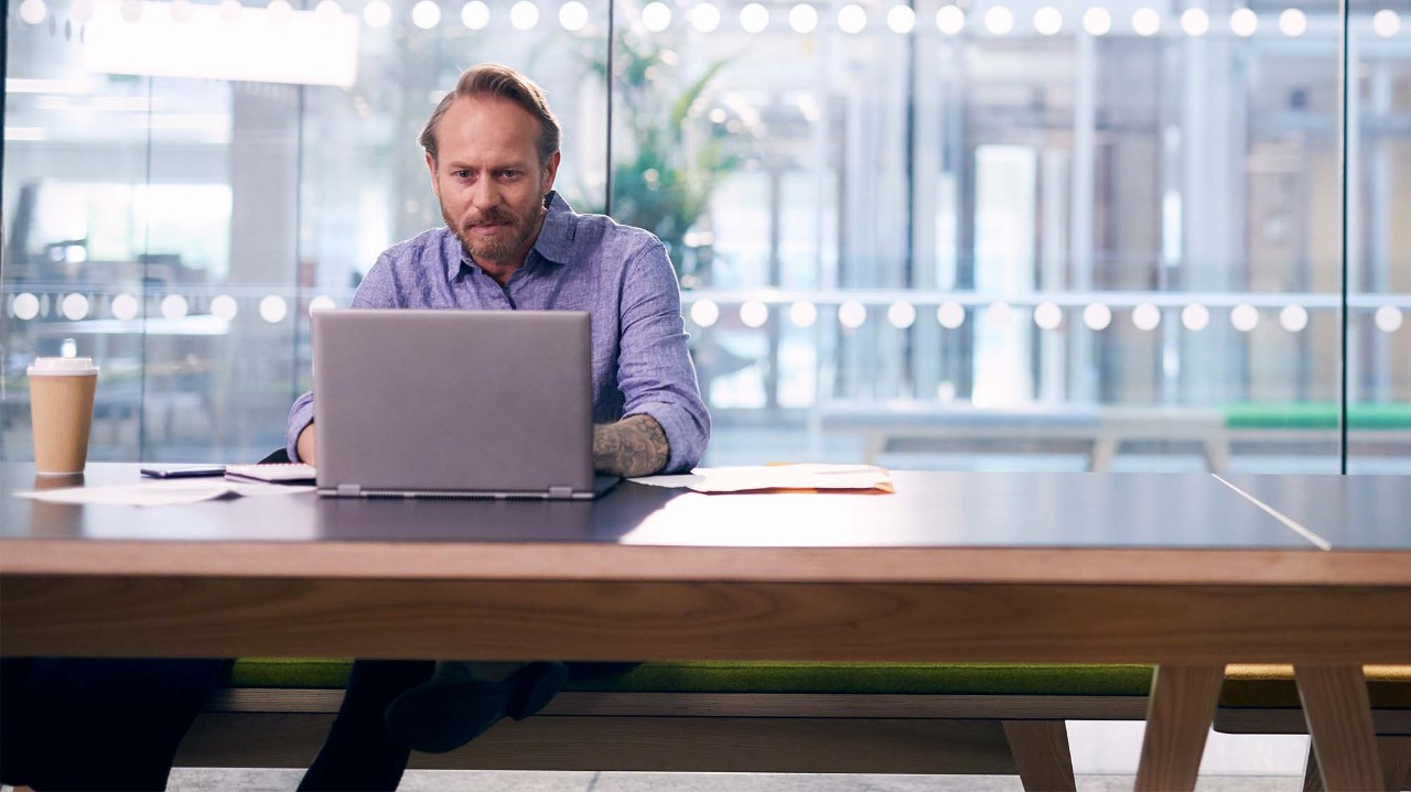 Man with laptop in conference room