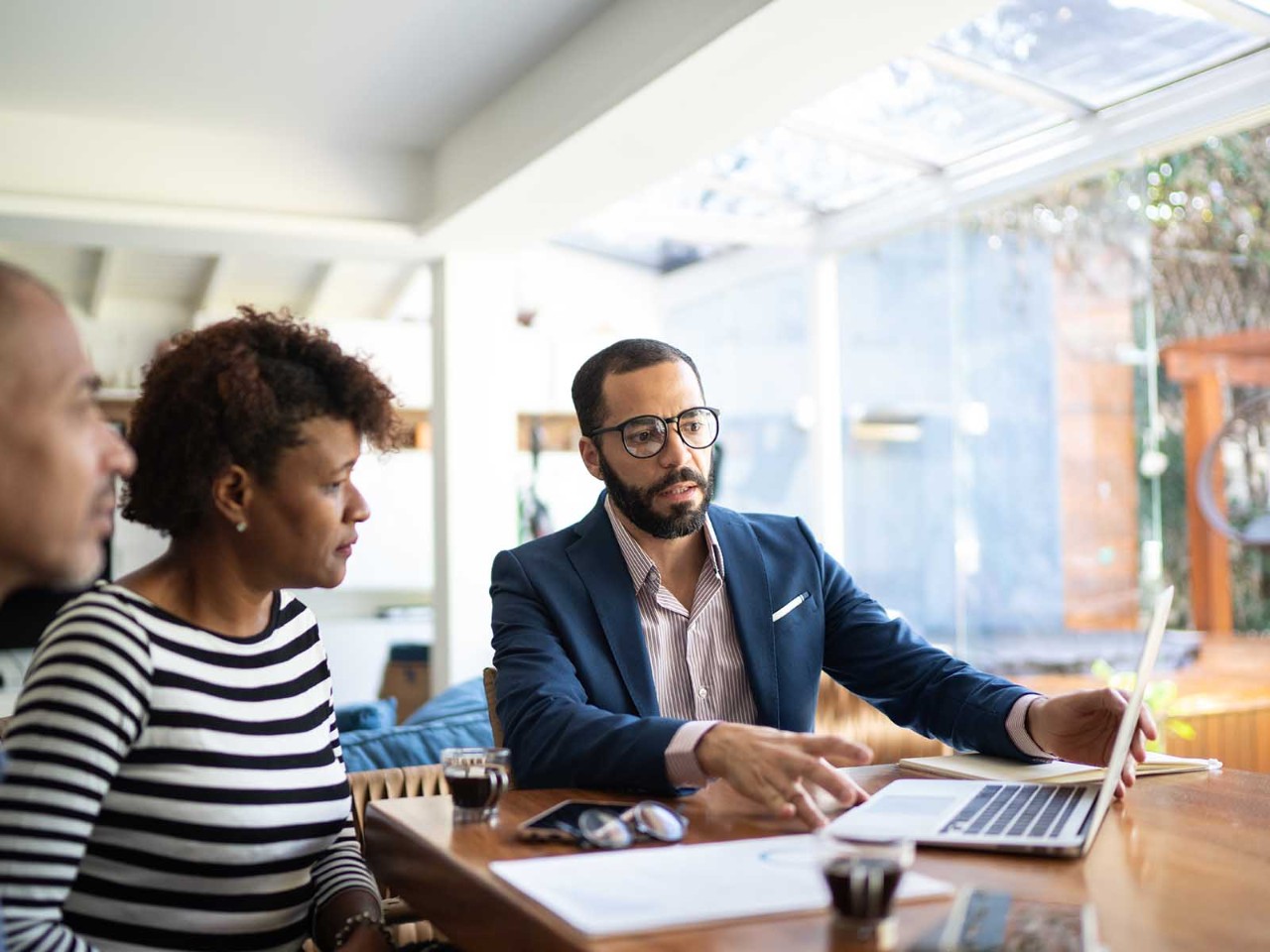 Couple talking to finance advisor at home