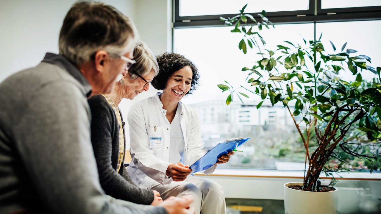 Female doctor reviewing results with older couple