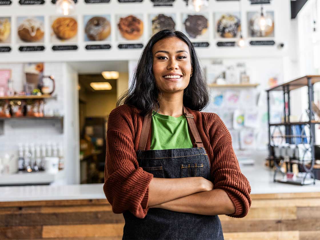 Small business woman smiling at camera standing in front of counter