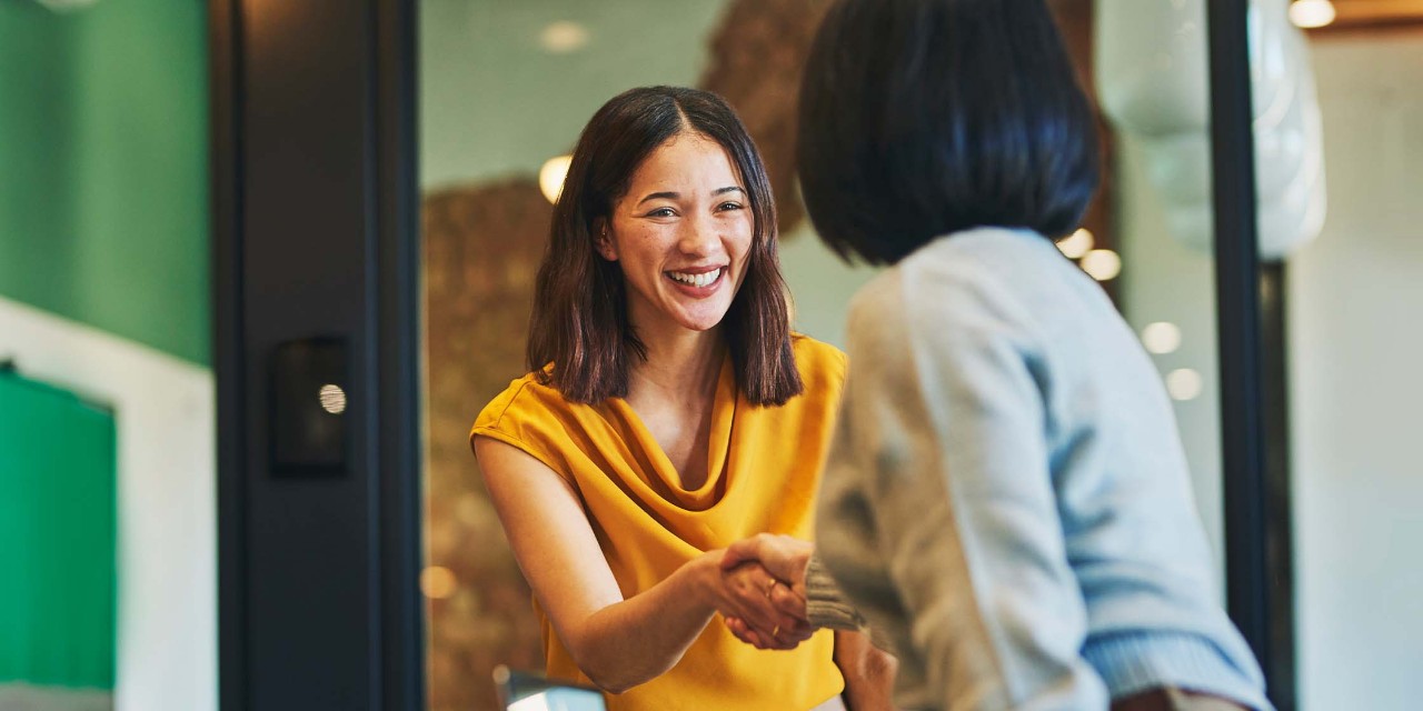 Woman shaking hands with her colleague